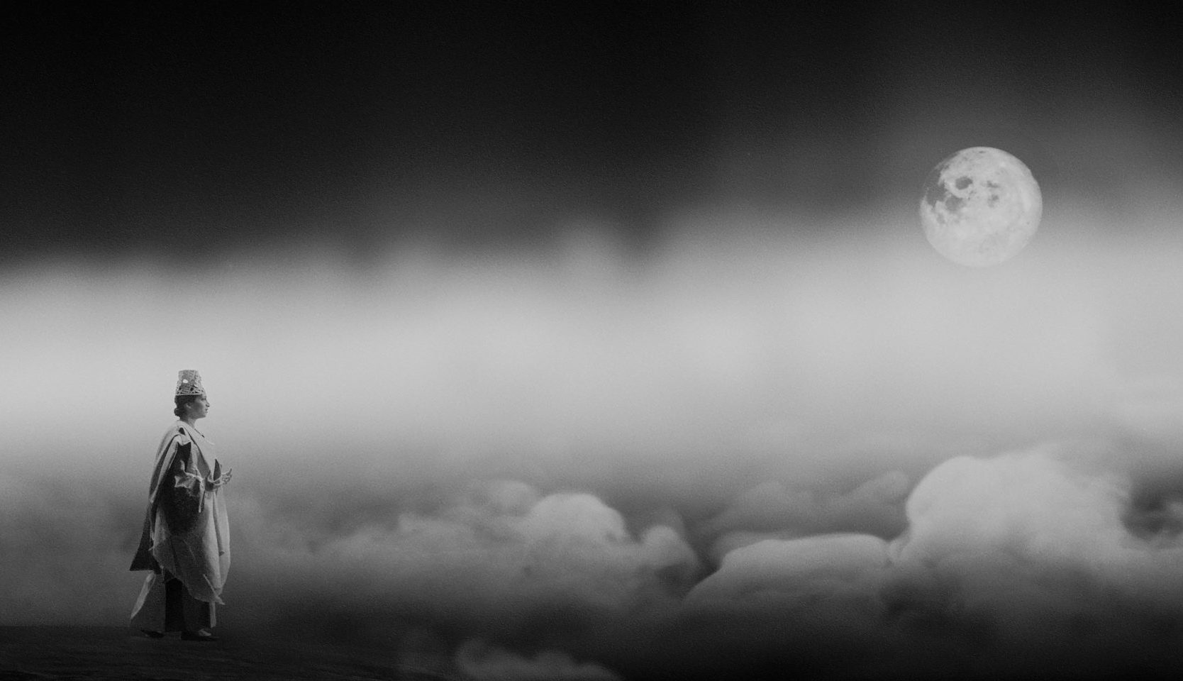 Black and white still photo of Palestinian soprano Nour Darwish in traditional Ottoman clothing among clouds and moon