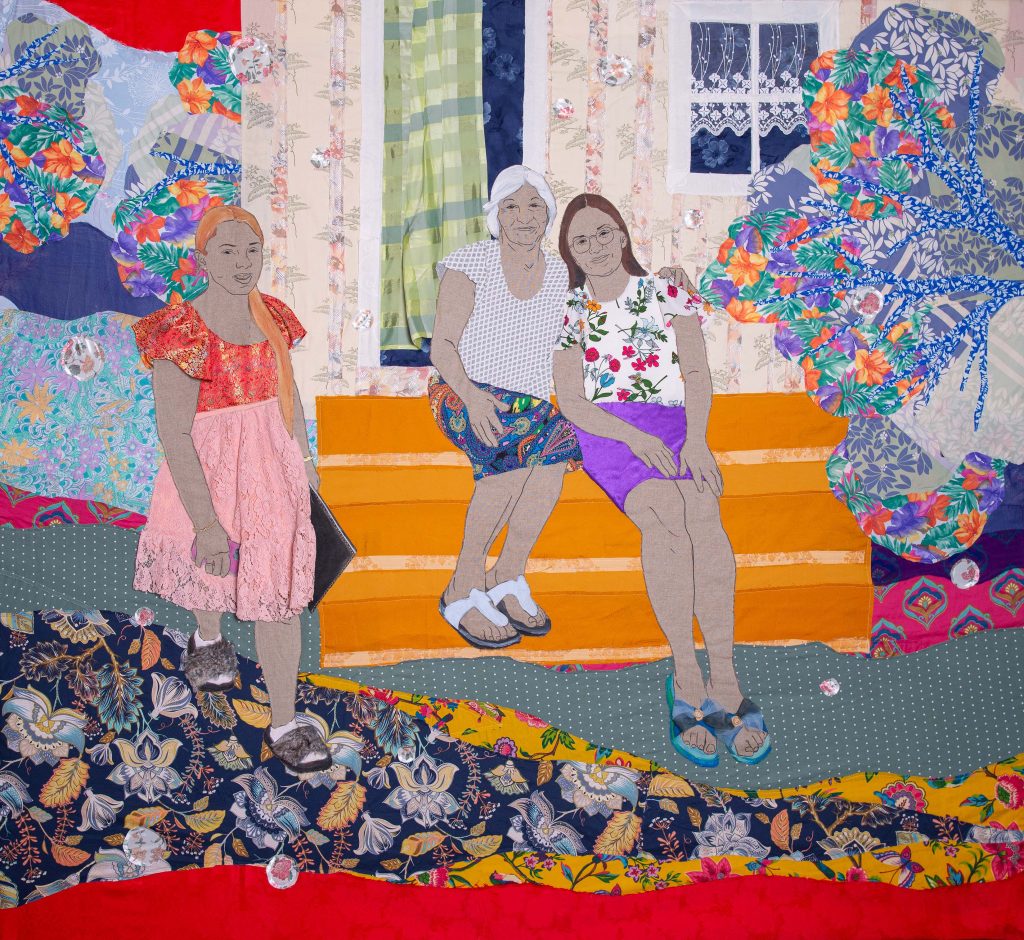 A textile artwork showing three women.