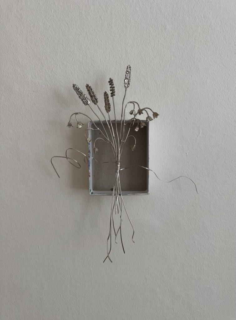 Silver decoration placed on a box.